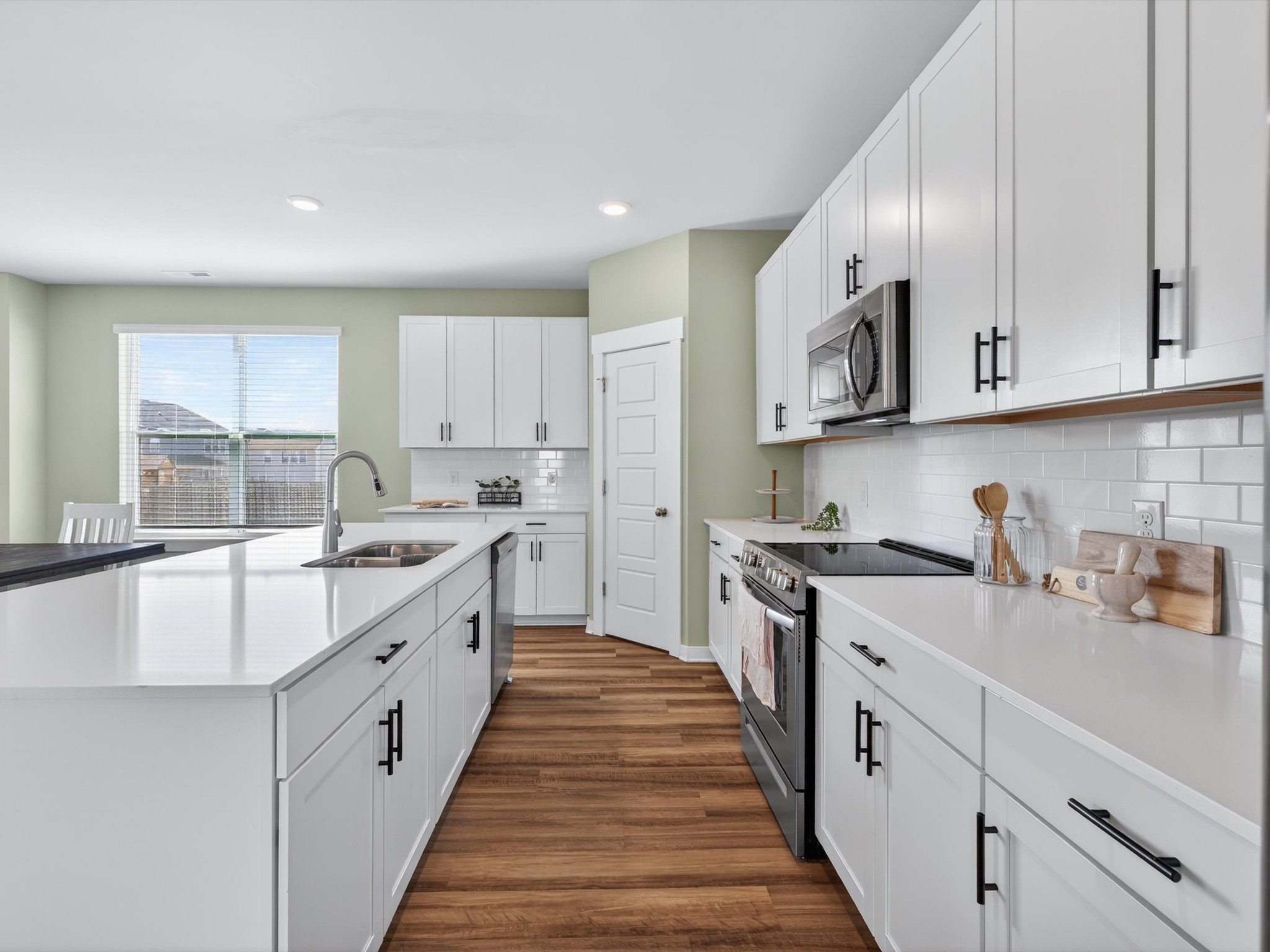 145 Southwind Run Spring Hill, TN 37174 - Photo 9 of 62 a large kitchen with stainless steel appliances granite countertop a sink and cabinets