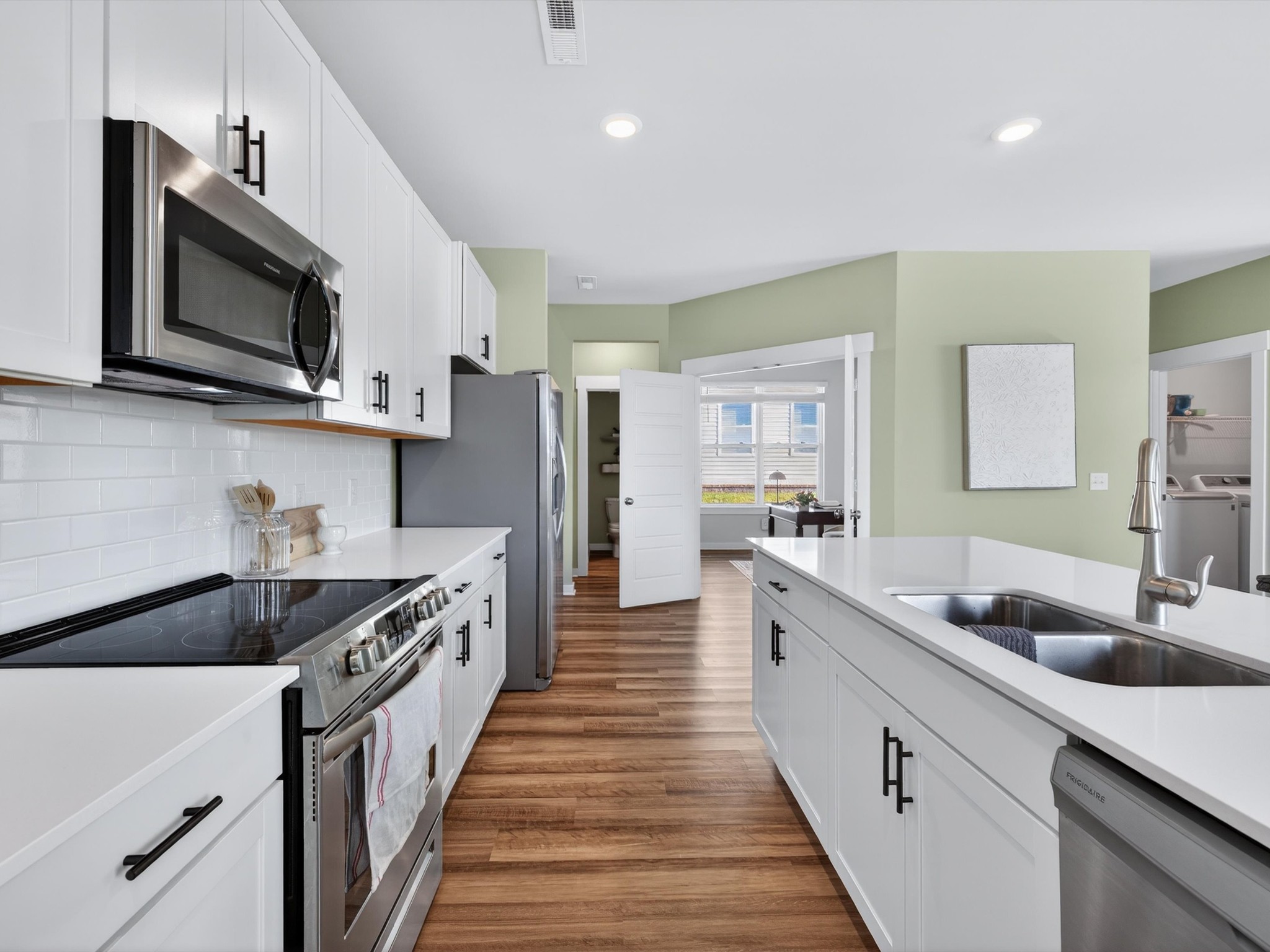 145 Southwind Run Spring Hill, TN 37174 - Photo 10 of 62 a kitchen with stainless steel appliances a sink stove top oven and refrigerator