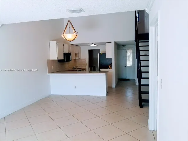 a view of a kitchen with a sink and a cabinets