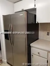 a close view of a sink and cabinets
