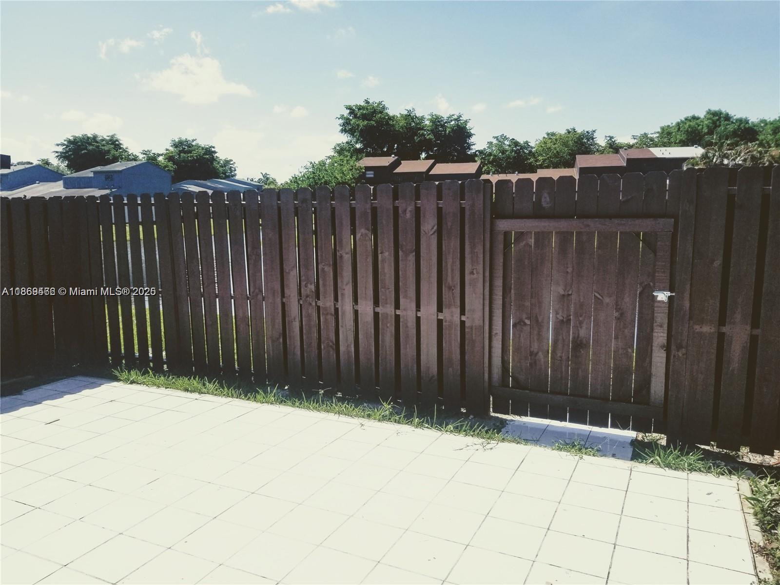 6943 Southwest 40th Street, Unit 11R Miramar, FL 33023 - Photo 6 of 11 a view of wooden fence