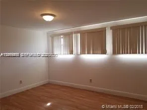 an empty room with wooden floor