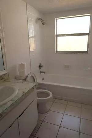 a bathroom with a sink a toilet and a bathtub