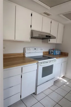 a kitchen with stainless steel appliances granite countertop a sink and a stove