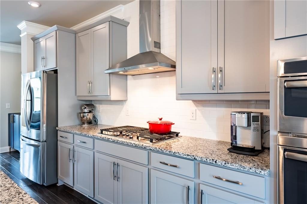 4062 Townsend Lane Atlanta, GA 30346 - Photo 11 of 52 a kitchen with granite countertop stainless steel appliances a sink stove and refrigerator