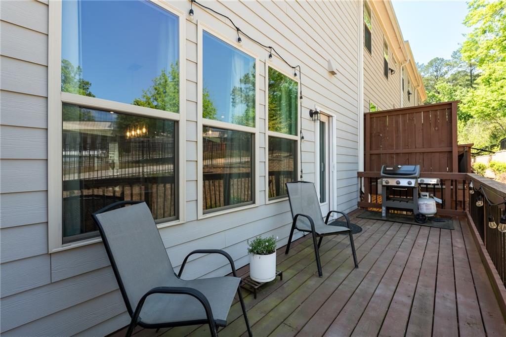 4062 Townsend Lane Atlanta, GA 30346 - Photo 19 of 52 a view of a balcony with chairs and wooden floor