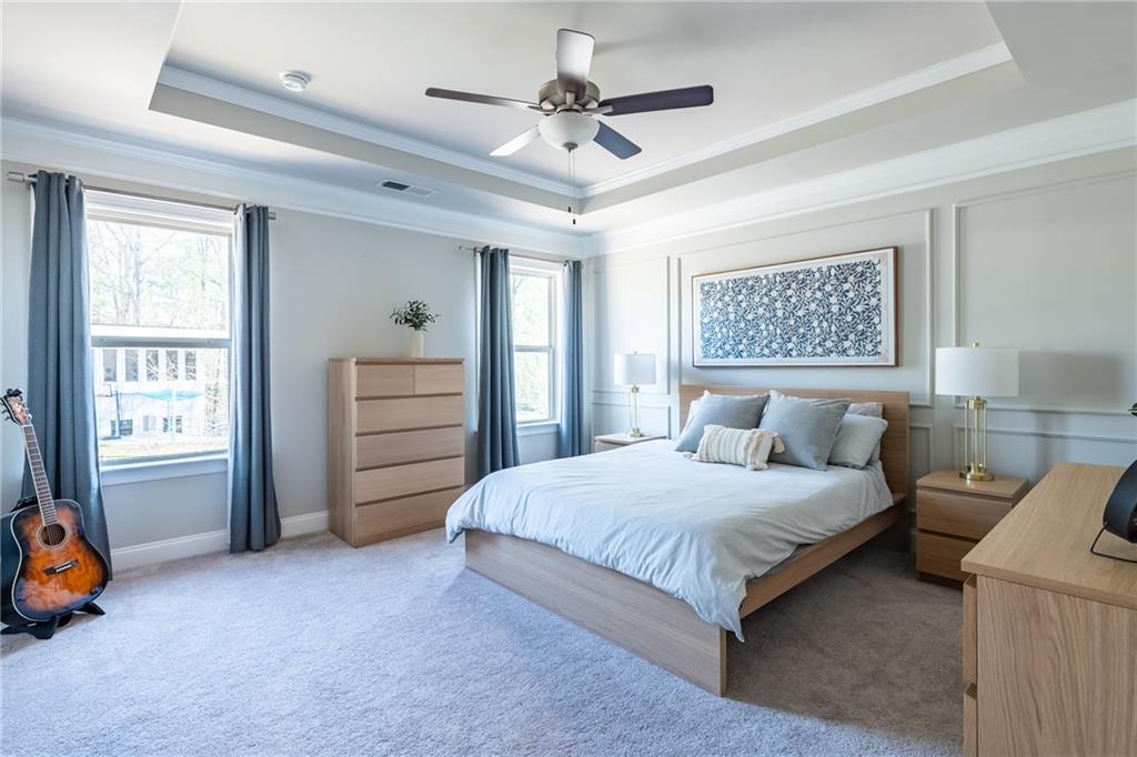 4062 Townsend Lane Atlanta, GA 30346 - Photo 23 of 52 a bedroom with a bed and a chandelier