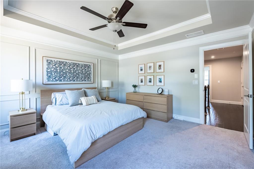 4062 Townsend Lane Atlanta, GA 30346 - Photo 24 of 52 a spacious bedroom with a bed and a chandelier