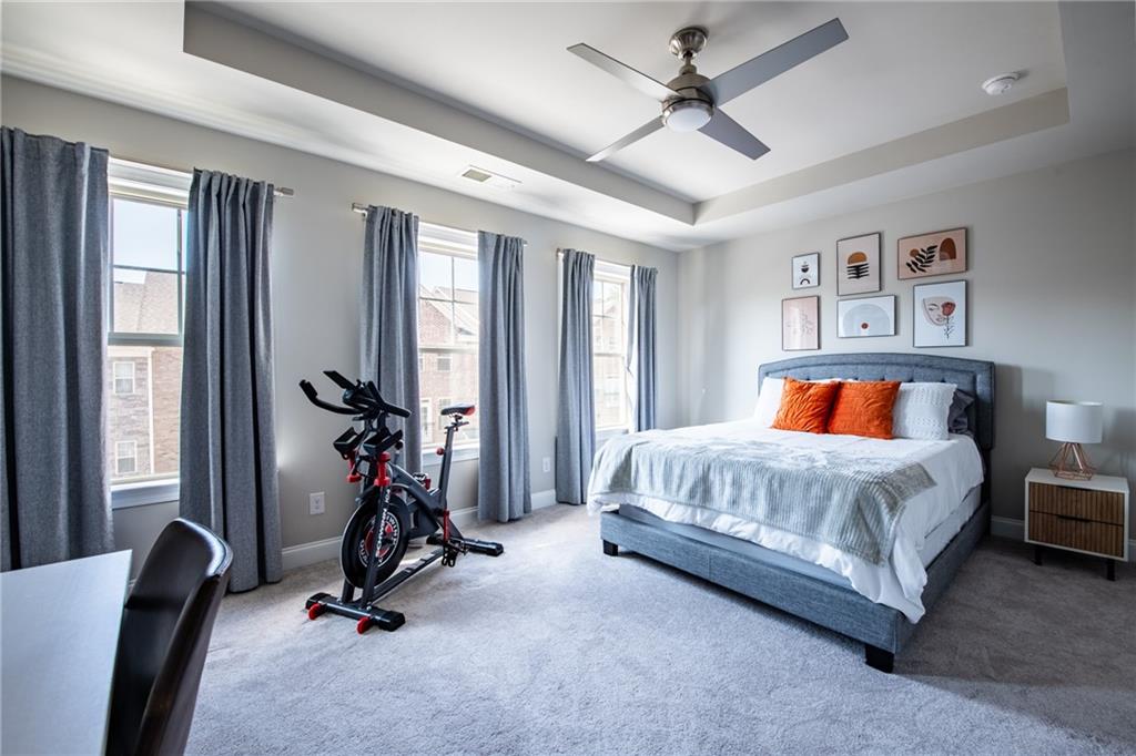 4062 Townsend Lane Atlanta, GA 30346 - Photo 28 of 52 a bedroom with a bed a couch and a chandelier