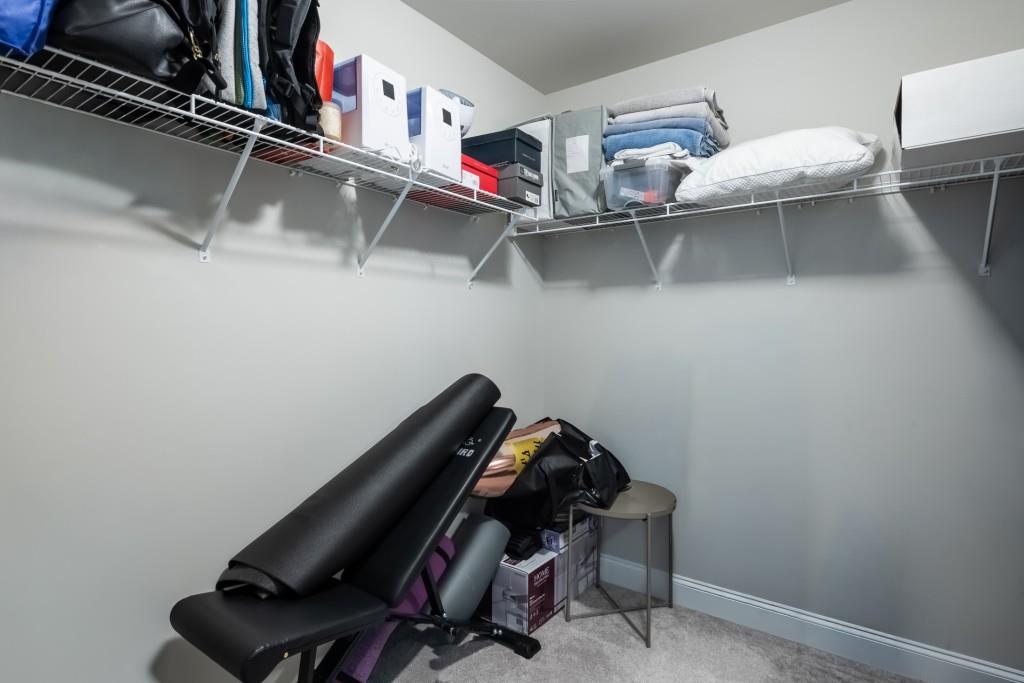 4062 Townsend Lane Atlanta, GA 30346 - Photo 31 of 52 a view of walk in closet with clothes and shoes