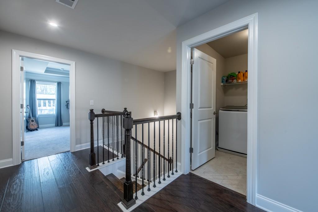 4062 Townsend Lane Atlanta, GA 30346 - Photo 32 of 52 a view of a hallway with wooden floor and stairs