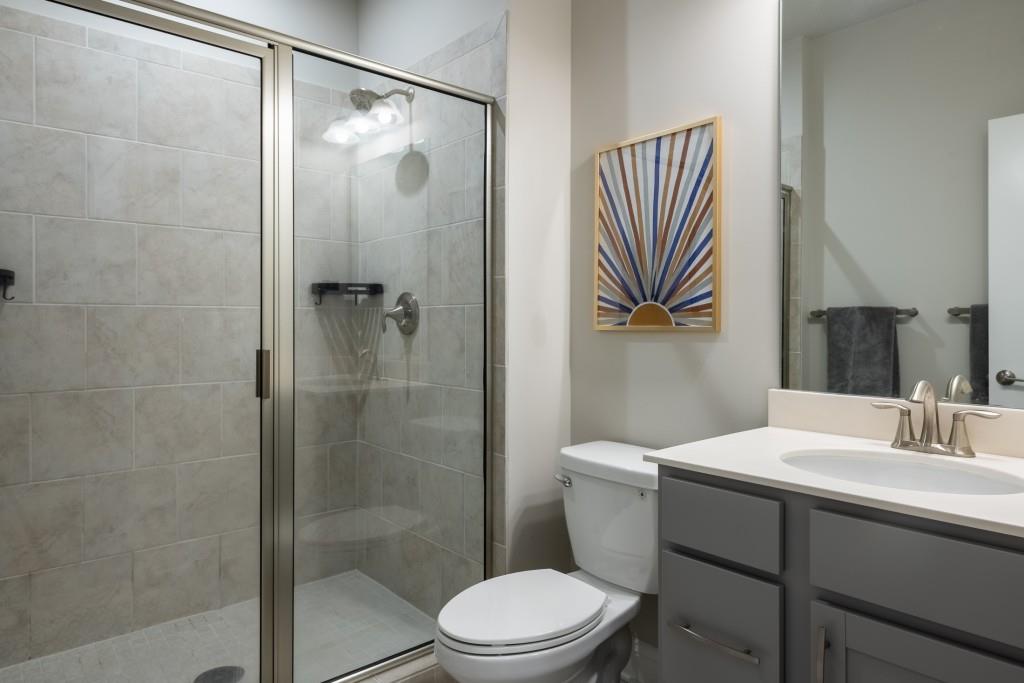 4062 Townsend Lane Atlanta, GA 30346 - Photo 36 of 52 a bathroom with a sink a toilet and shower