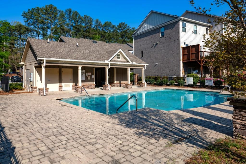 4062 Townsend Lane Atlanta, GA 30346 - Photo 38 of 52 a front view of a house with garden and trees