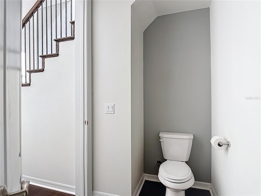 1513 Resolute Street Celebration, FL 34747 - Photo 19 of 43 a white toilet sitting next to a bathroom sink