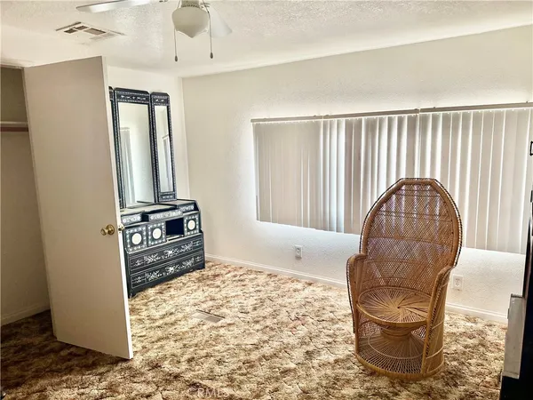 a view of a livingroom with wooden floor and a cabinet