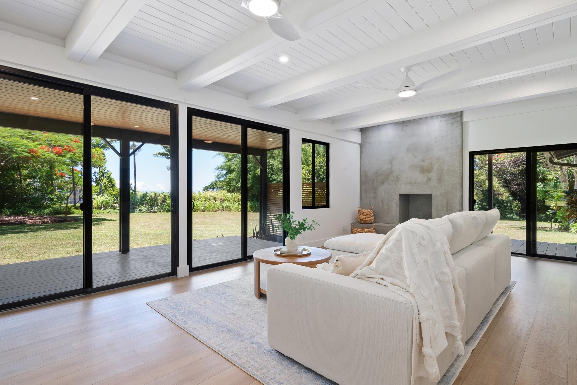 965 Hog Back Road Haiku, HI 96708 - Photo 5 of 44 a living room with furniture and floor to ceiling windows