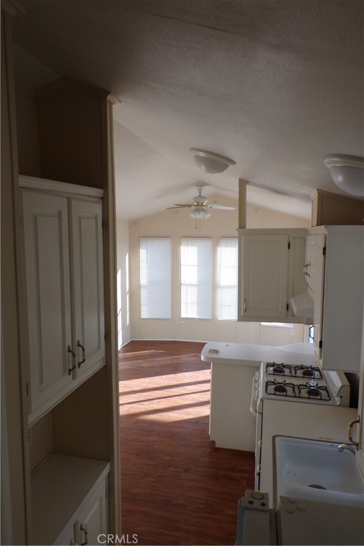 12710 3rd Street, Unit SPC 103 Yucaipa, CA 92399 - Photo 3 of 8 a kitchen with stainless steel appliances a stove and a refrigerator
