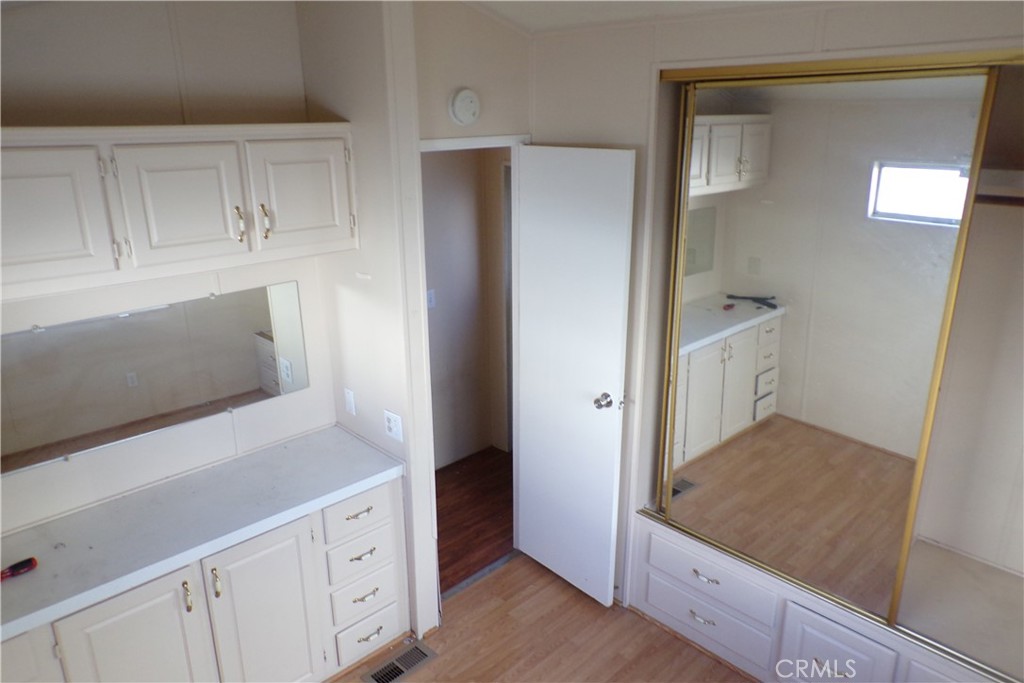 12710 3rd Street, Unit SPC 103 Yucaipa, CA 92399 - Photo 7 of 8 a view of kitchen with furniture and wooden floor