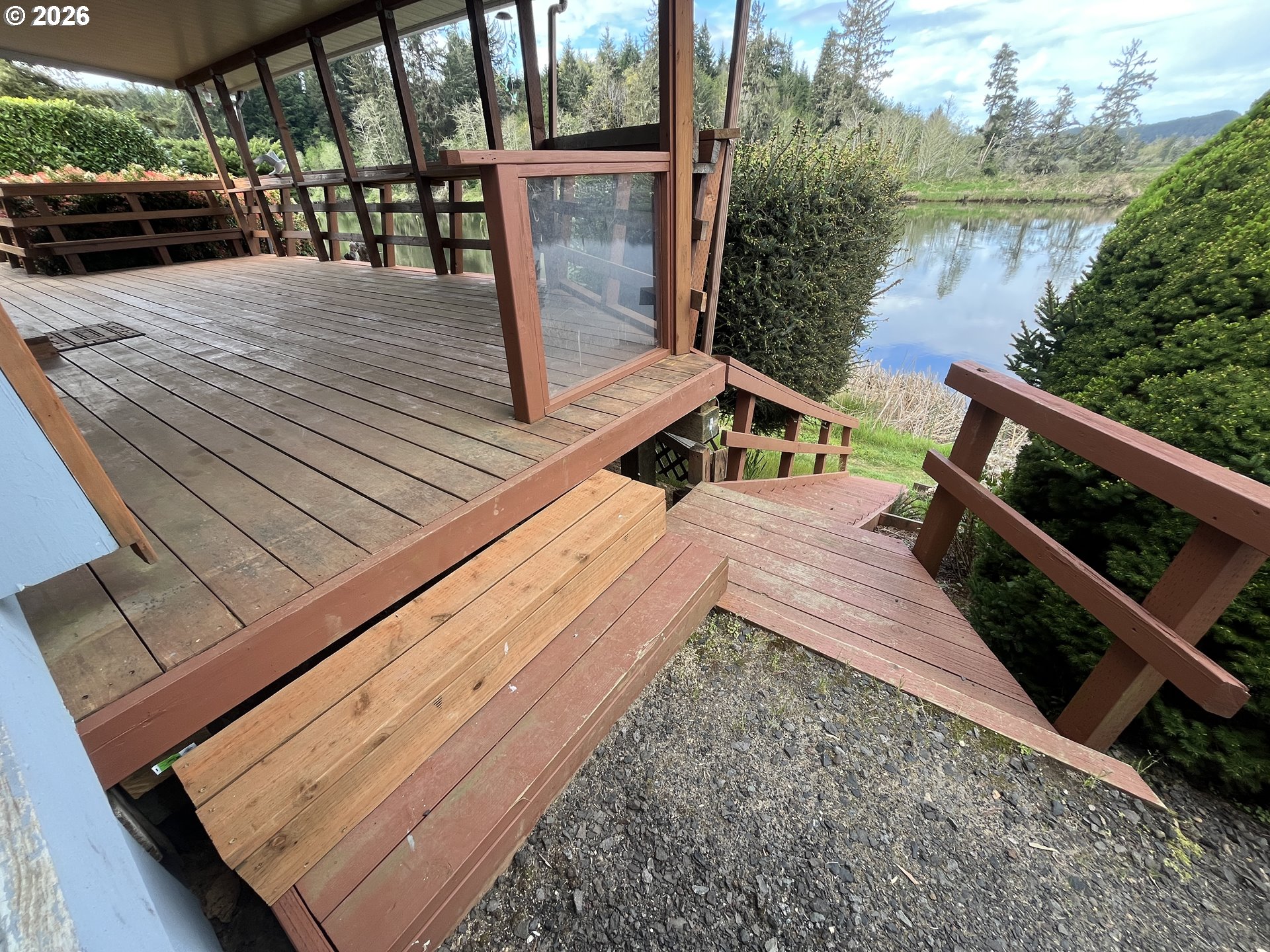 100 River Bend Road, Unit 23 Reedsport, OR 97467 - Photo 40 of 41 a view of a balcony with wooden floor and lake view