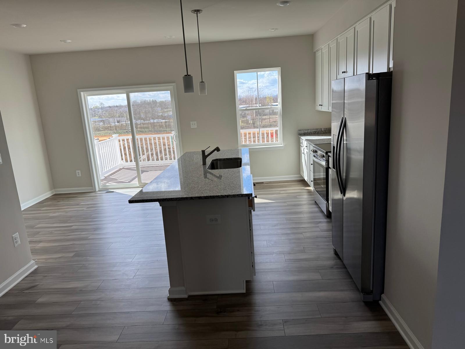 1257 Cedar Vly Road Ranson, WV 25438 - Photo 12 of 13 a kitchen with stainless steel appliances granite countertop a refrigerator a sink dishwasher a stove and white countertops with wooden floor