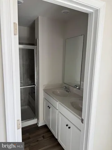 a bathroom with a granite countertop sink and mirror