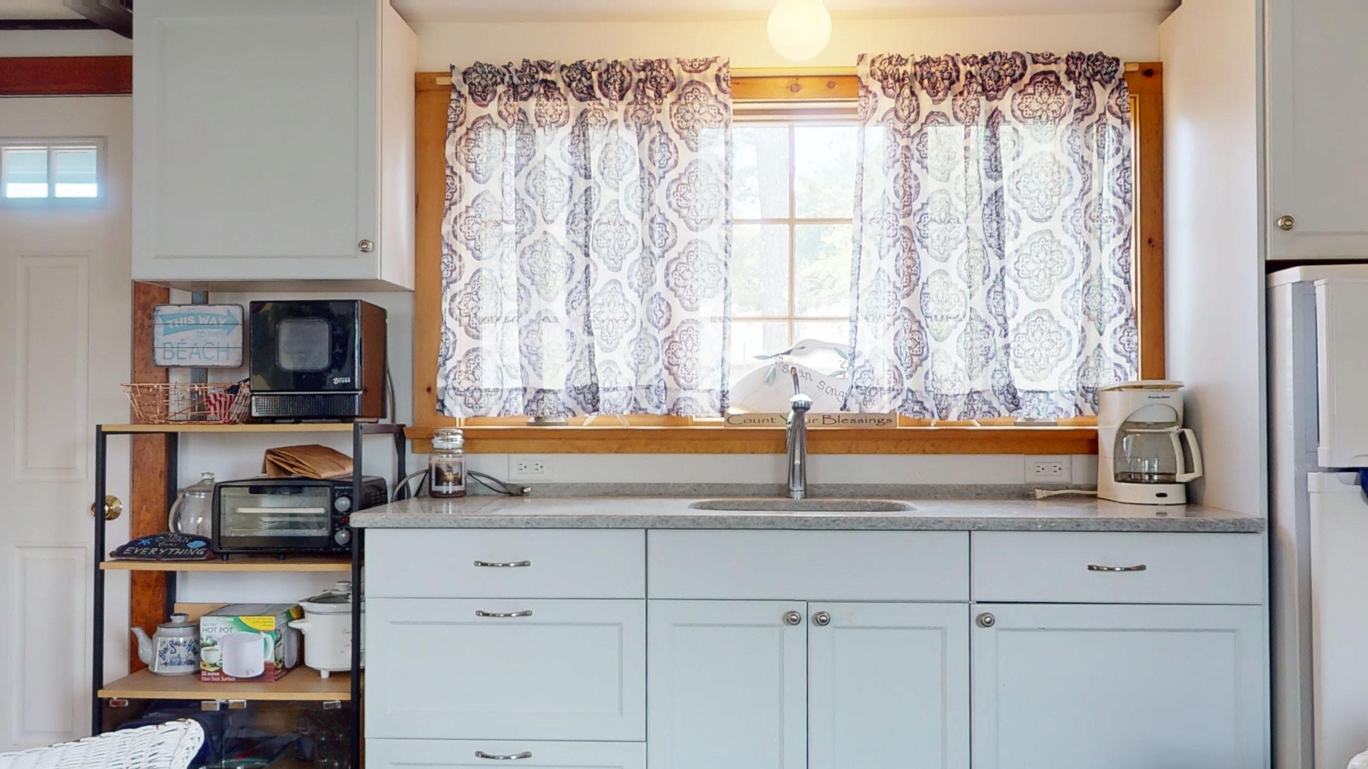 18 Myrtle Lane Dennis Port, MA 02639 - Photo 7 of 25 a kitchen with a sink and a window