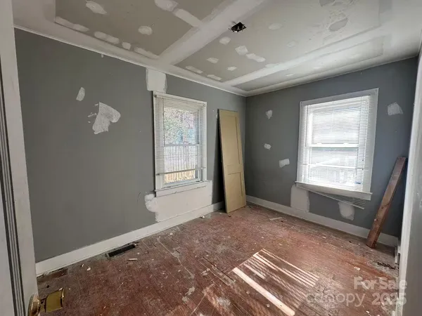 an empty room with windows and closet