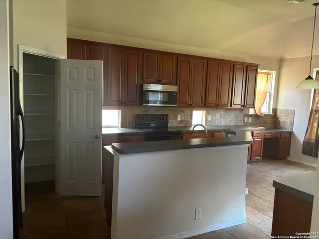 a bathroom with a sink a large mirror and shower