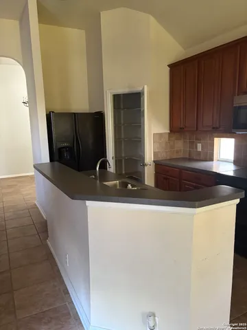 a view of lobby with kitchen view and wooden floor