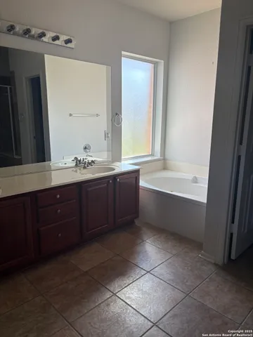 an empty room with a windows and painted walls