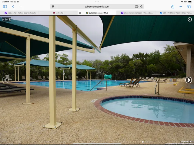 a view of a swimming pool with a patio