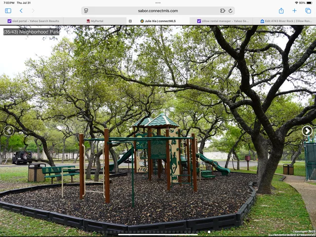 a view of outdoor space with seating area and trees around