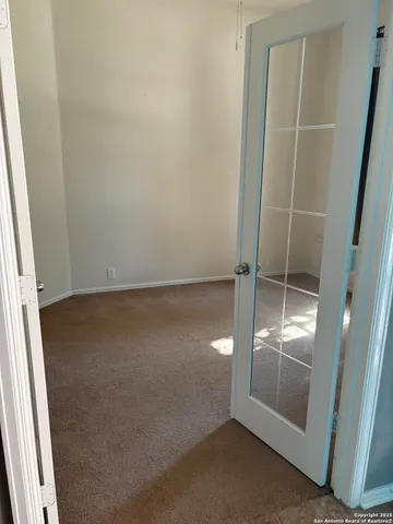 en empty room with sliding door and wooden floor