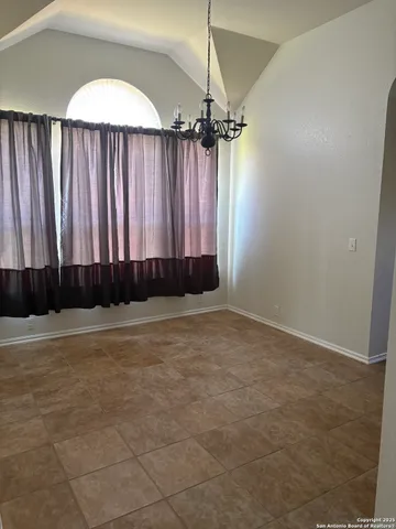 a view of a room with a window and a fan