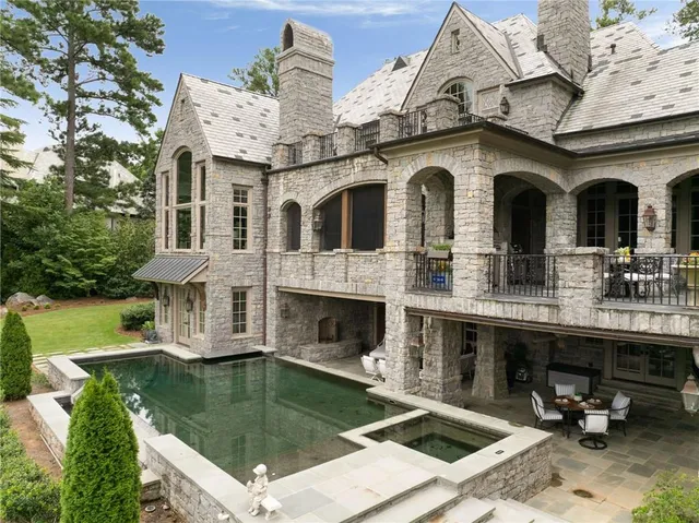 a kitchen with stainless steel appliances granite countertop a stove and white cabinets