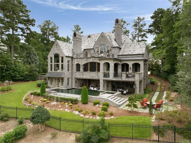 a kitchen with stainless steel appliances granite countertop a sink a stove and cabinets