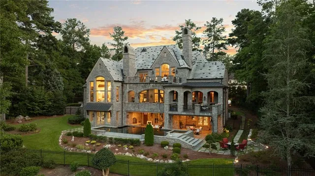 a front view of a house with swimming pool and glass windows