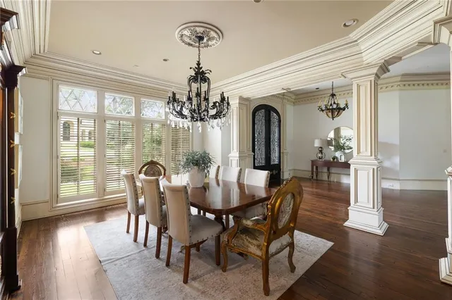a spacious bedroom with a bed and wooden floor