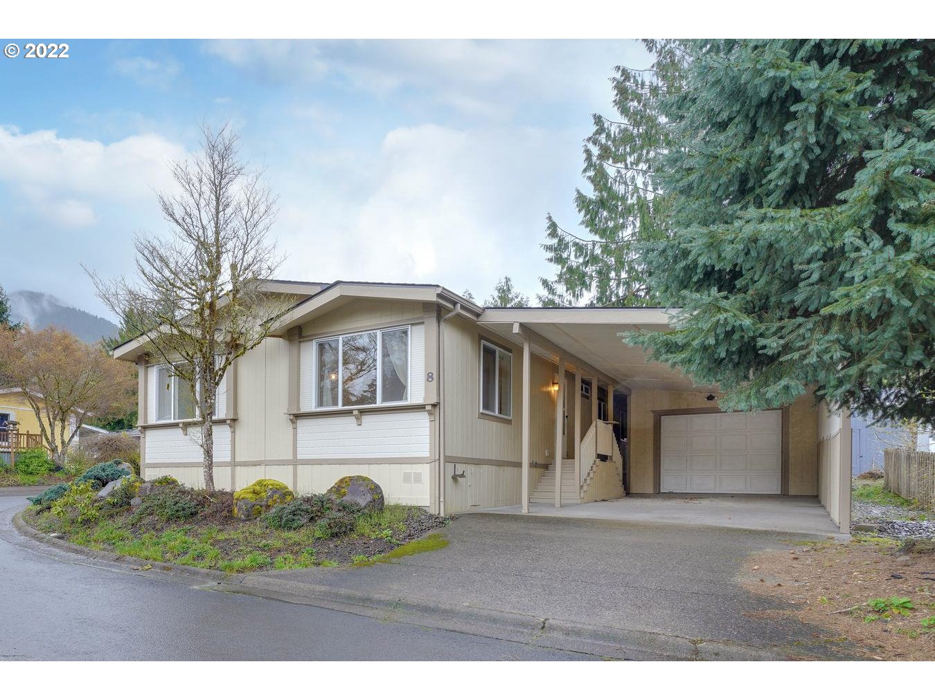 25222 East Welches Road, Unit 8 Welches, OR 97067 - Photo 29 of 31 a front view of a house with a yard and garage
