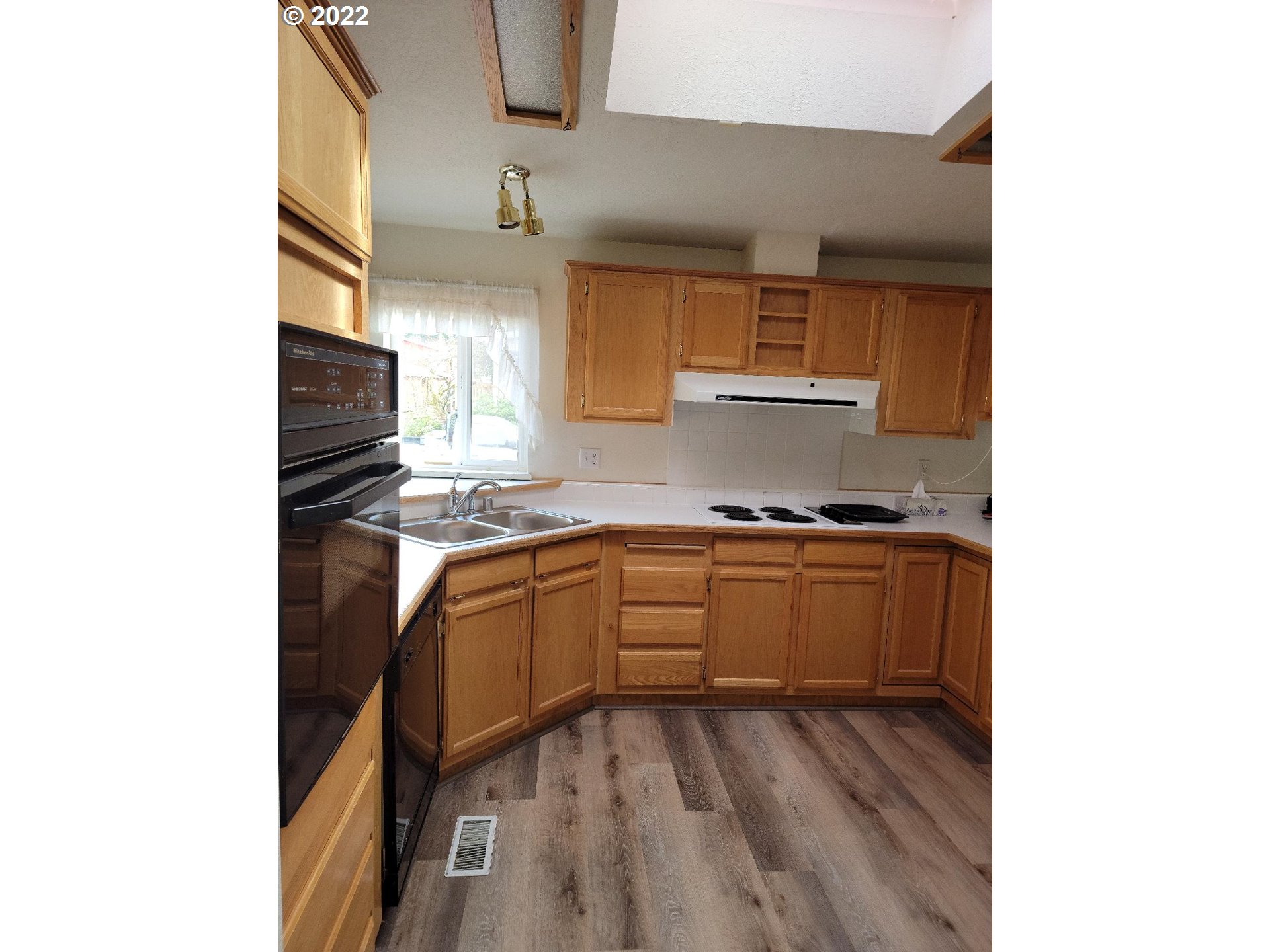 25222 East Welches Road, Unit 8 Welches, OR 97067 - Photo 3 of 31 a kitchen with granite countertop a sink cabinets and stainless steel appliances