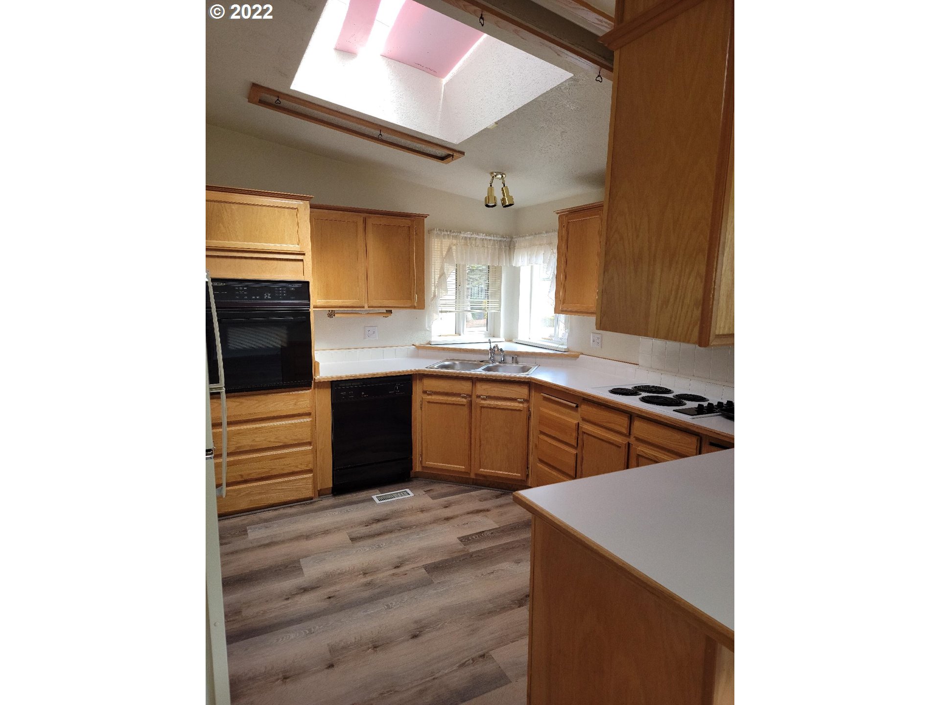 25222 East Welches Road, Unit 8 Welches, OR 97067 - Photo 4 of 31 a kitchen with stainless steel appliances granite countertop a sink and a stove top oven