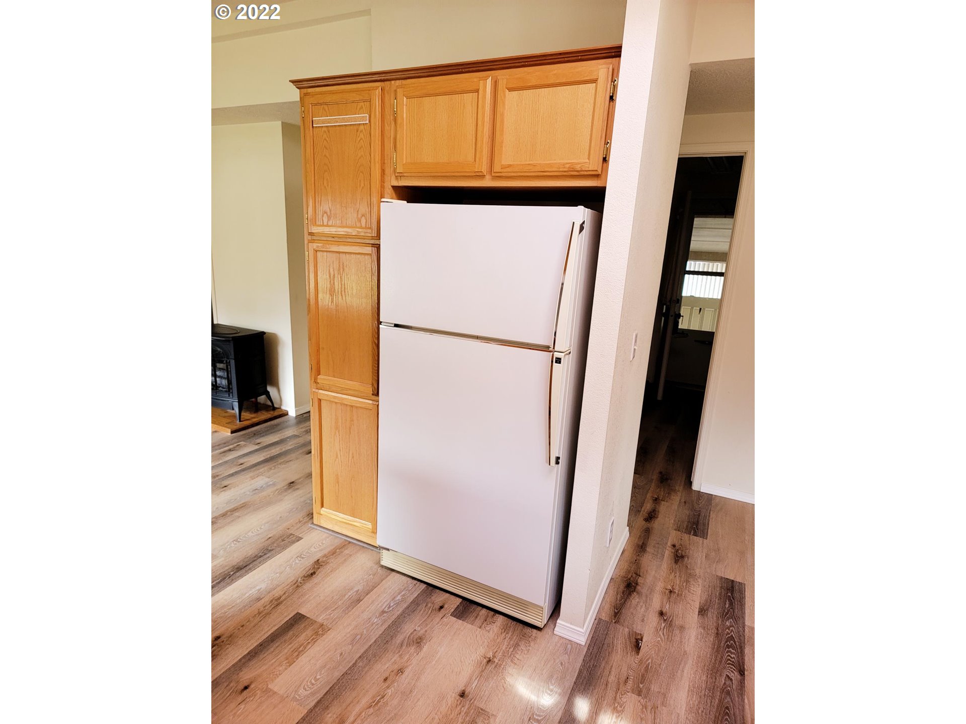 25222 East Welches Road, Unit 8 Welches, OR 97067 - Photo 6 of 31 a view of a refrigerator in kitchen and an empty room