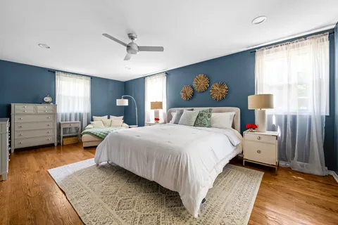 a bedroom with a large bed and a window