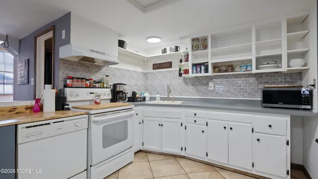 a kitchen with cabinets appliances and a sink