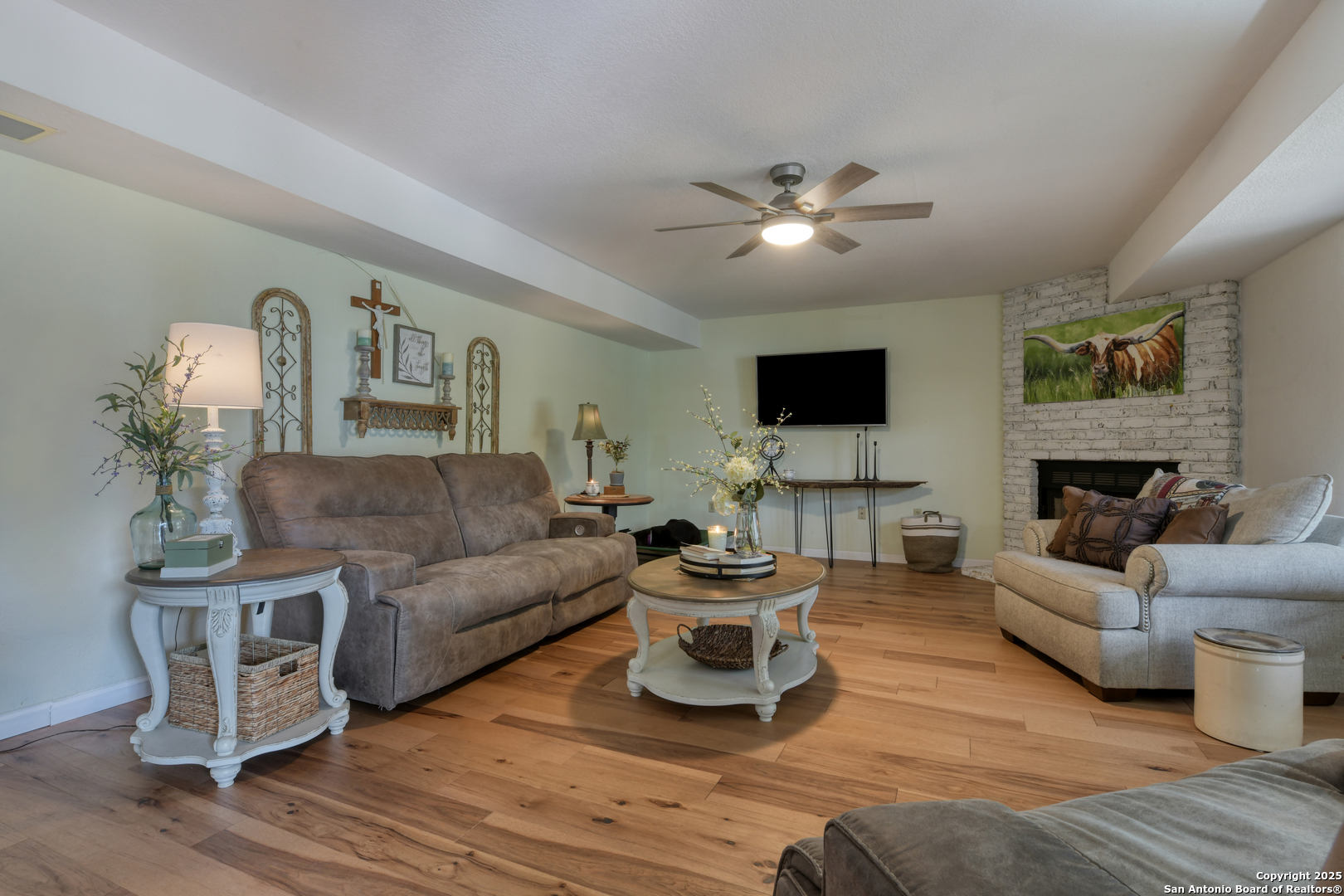 510 Rudeloff Road Seguin, TX 78155 - Photo 28 of 54 a living room with furniture a fireplace and a flat screen tv