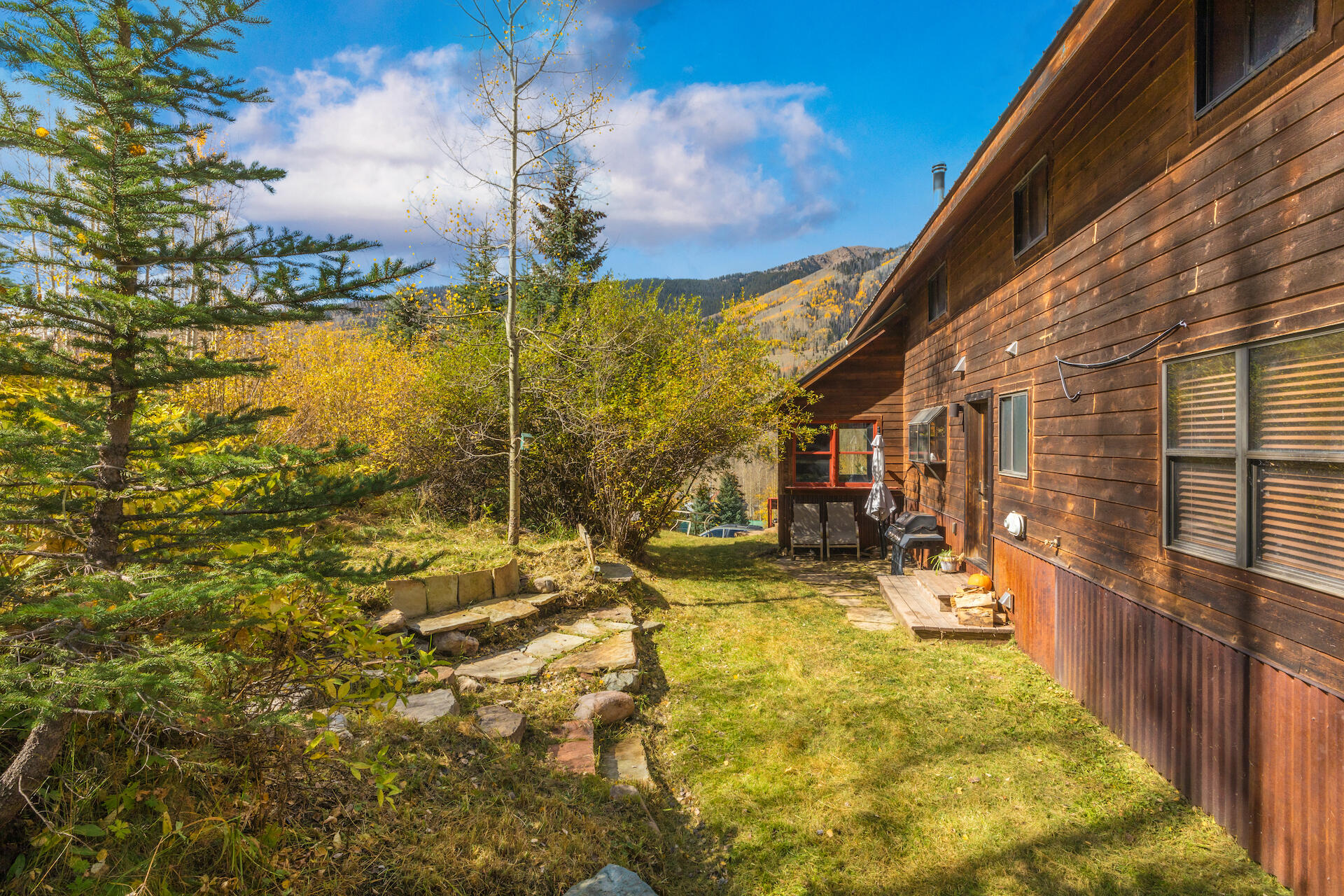 15 South Garfield Street Rico, CO 81332 - Photo 40 of 43 a view of a backyard with table and chairs with wooden fence