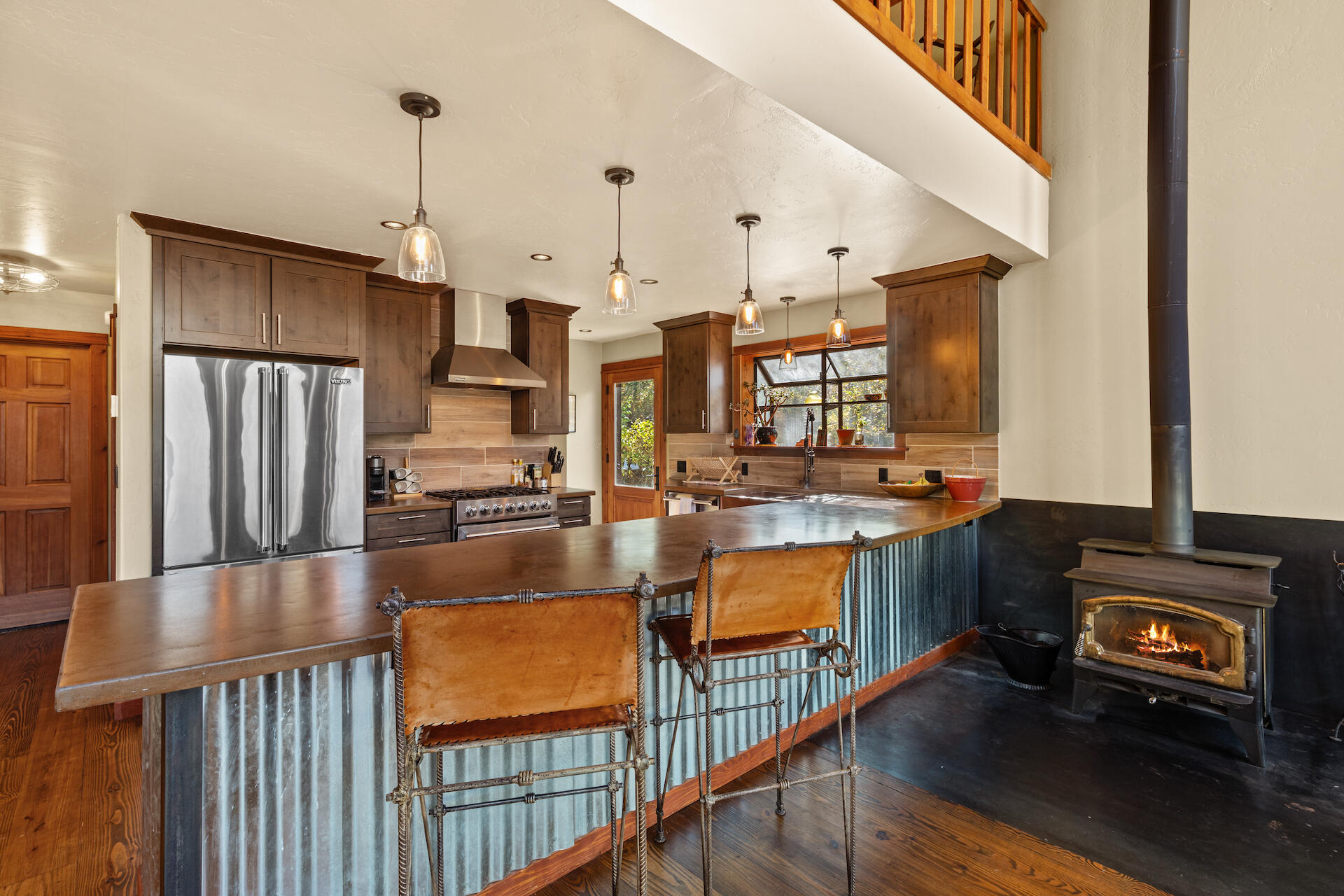 15 South Garfield Street Rico, CO 81332 - Photo 6 of 43 a kitchen with stainless steel appliances granite countertop a refrigerator a stove and a dining table with wooden floor