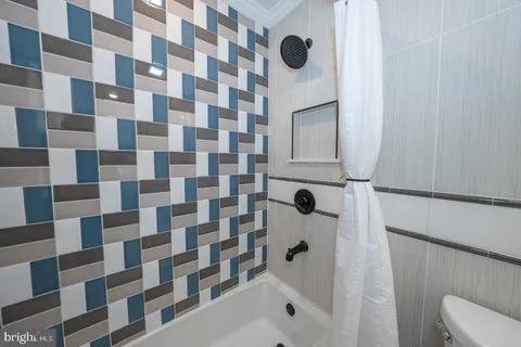 a bathroom with a shower toilet and a sink