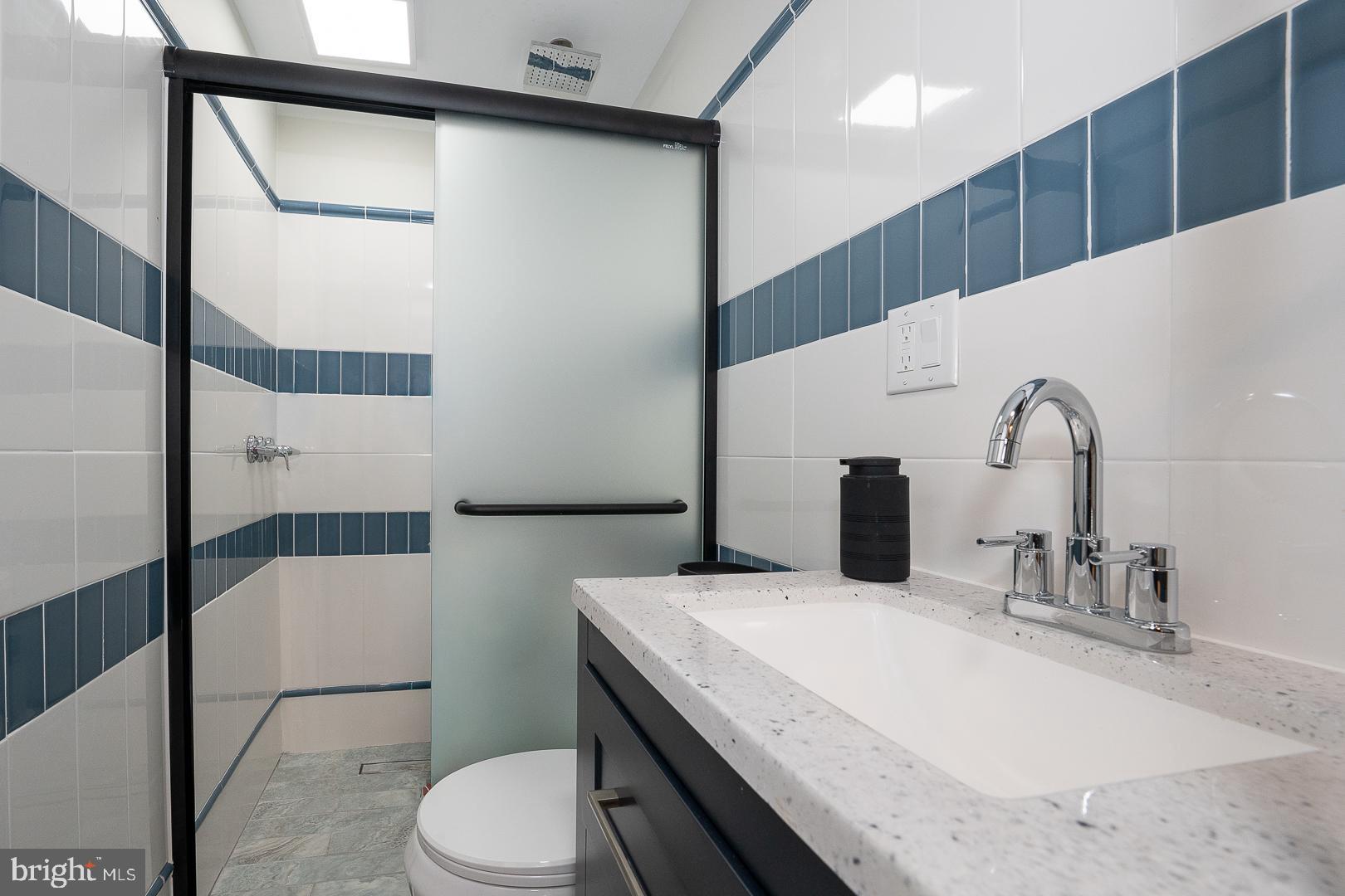 1022 Clover Hill Road Wynnewood, PA 19096 - Photo 26 of 40 a bathroom with a sink a toilet and shower