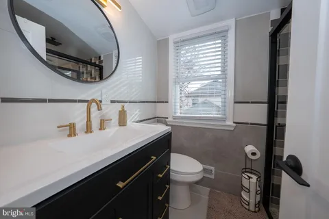 a bathroom with a glass shower door and a sink